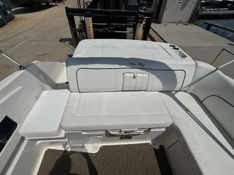 Slide: The Image of 2014 Sea Ray 240 Sundeck boat interior with white seating and logo. - 8