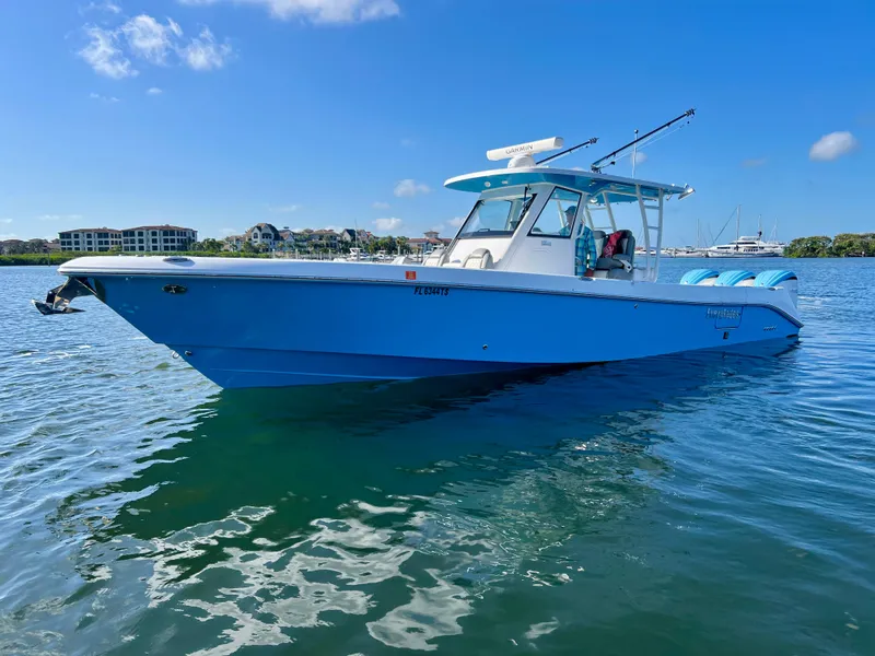 The Image of 2023 Everglades 365 Center Console boat on calm water under clear blue sky. - 0