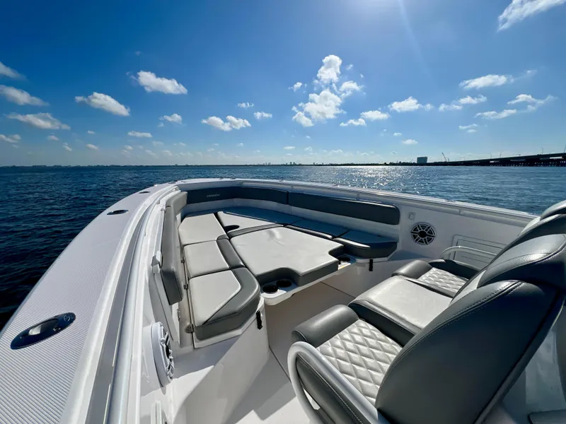 Slide: The Image of 2023 Everglades 365 Center Console boat interior with luxurious seating on open water. - 10