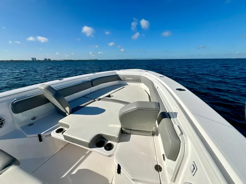 Slide: The Image of 2023 Everglades 365 Center Console boat on open water, featuring spacious seating and clear skies. - 12