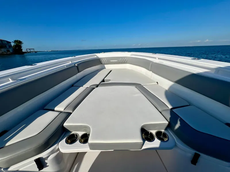 Slide: The Image of 2023 Everglades 365 Center Console boat interior with cushioned seating and cup holders. - 13