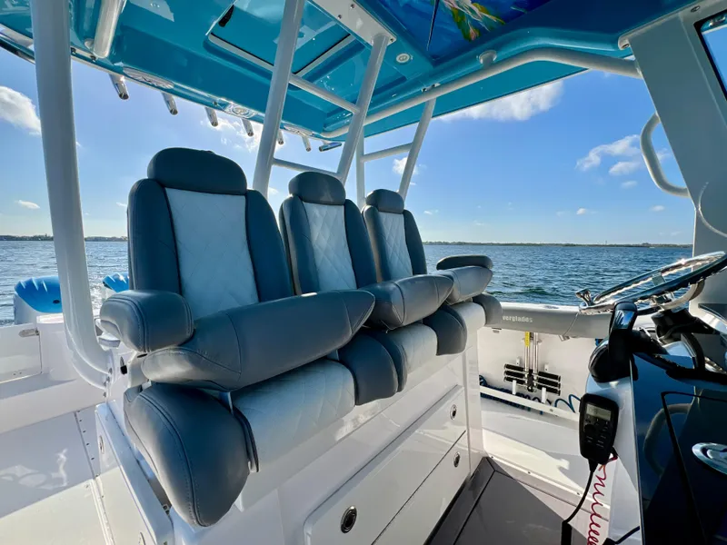 Slide: The Image of 2023 Everglades 365 Center Console boat interior with luxurious seating and ocean view. - 17