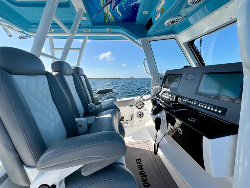 Slide: The Image of 2023 Everglades 365 Center Console interior with modern helm and luxurious seating. - 2