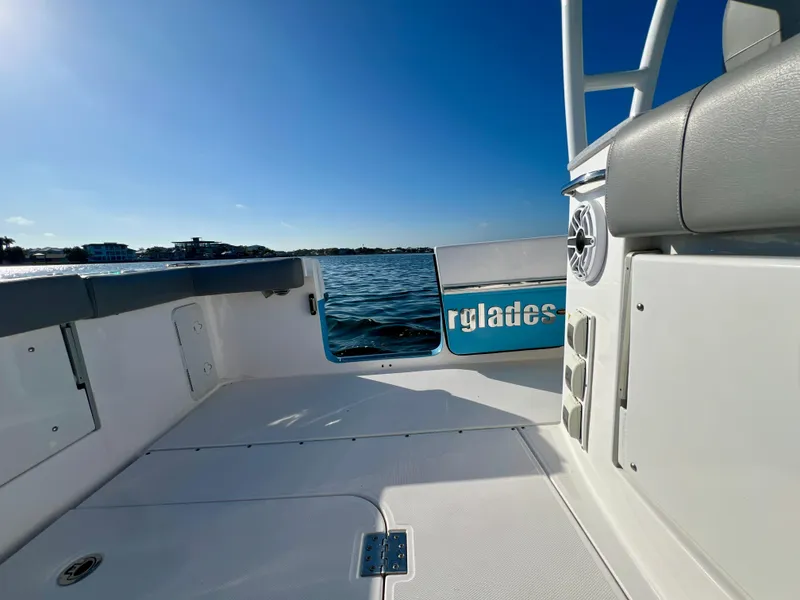 Slide: The Image of 2023 Everglades 365 Center Console boat on calm water under clear blue sky. - 21