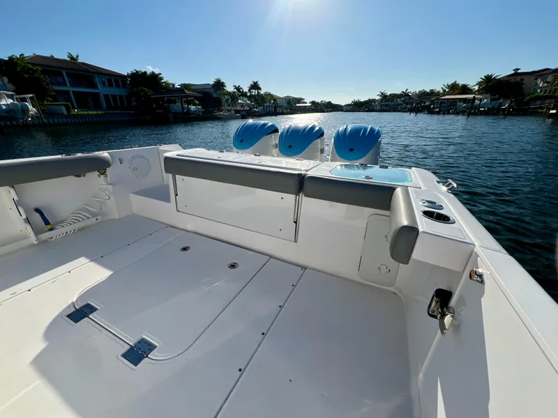 Slide: The Image of 2023 Everglades 365 Center Console boat on a sunny waterfront. - 22