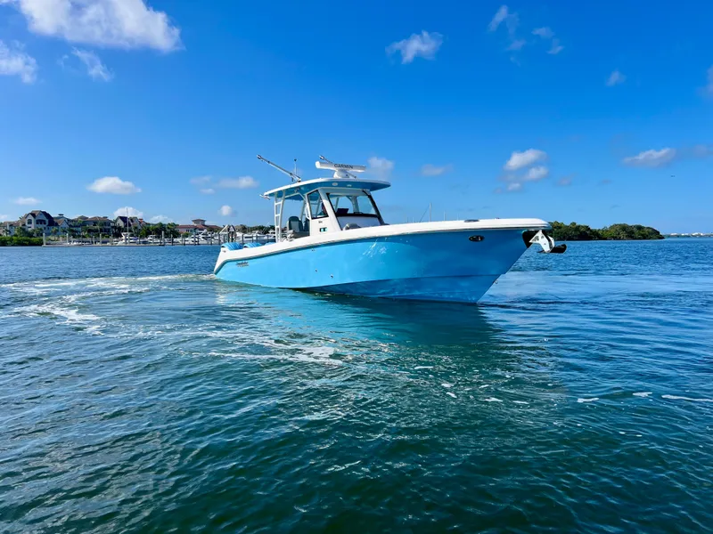 Slide: The Image of 2023 Everglades 365 Center Console boat cruising on a sunny day. - 31