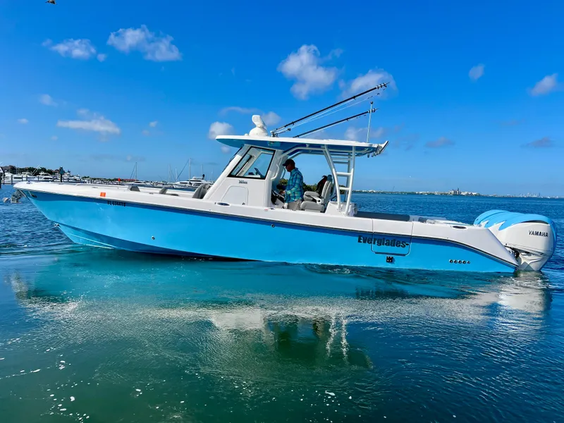 Slide: The Image of 2023 Everglades 365 Center Console boat on clear blue water under a sunny sky. - 32