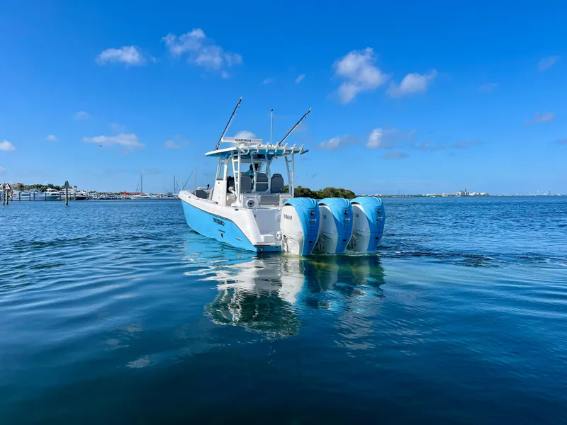 Slide: The Image of 2023 Everglades 365 Center Console boat on calm blue water under clear sky. - 33
