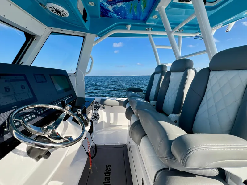 Slide: The Image of 2023 Everglades 365 Center Console interior with luxurious seating and advanced controls. - 7