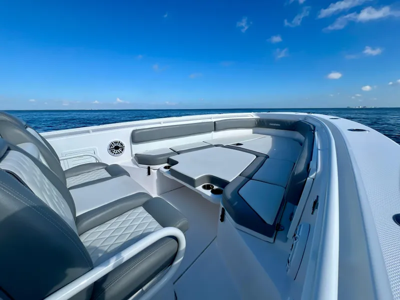 Slide: The Image of 2023 Everglades 365 Center Console boat interior with seating, ocean view, and blue sky. - 9