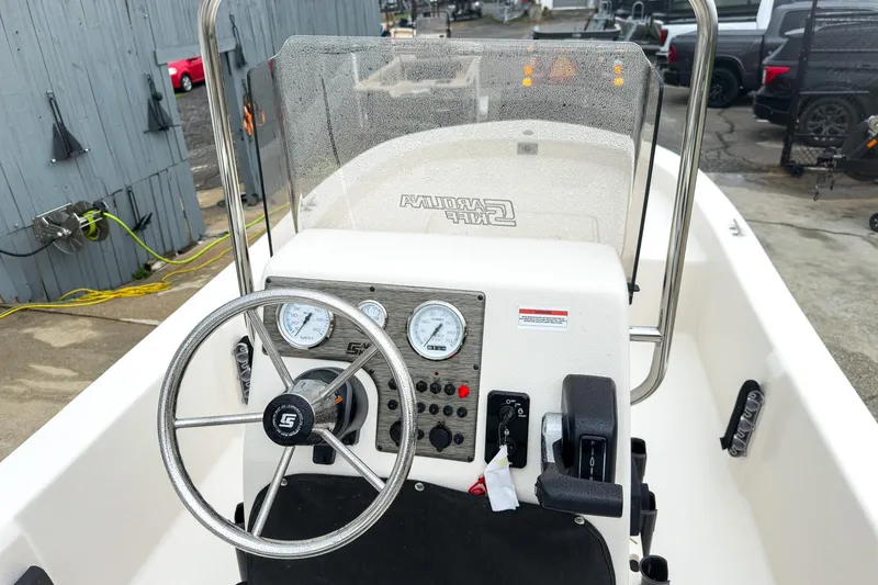 Slide: The Image of 2026 Carolina Skiff E20 JVX CC boat console with steering wheel and gauges. - 12
