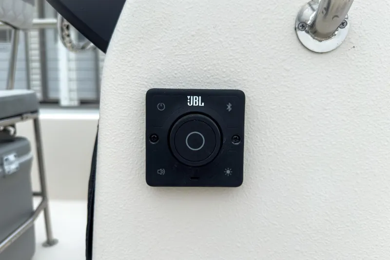 Slide: The Image of JBL control panel on 2026 Carolina Skiff E20 JVX CC boat dashboard. - 14