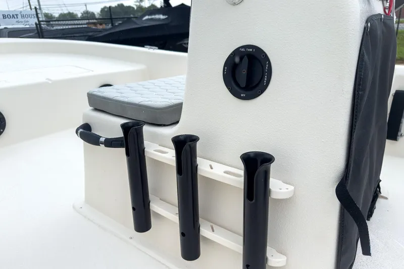Slide: The Image of 2026 Carolina Skiff E20 JVX CC boat console with rod holders and fuel tank switch. - 15