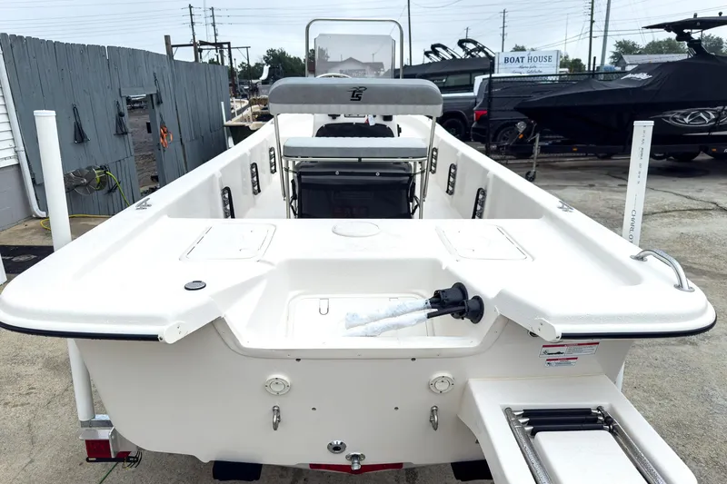 Slide: The Image of 2026 Carolina Skiff E20 JVX CC boat, white exterior, docked at a marina. - 19