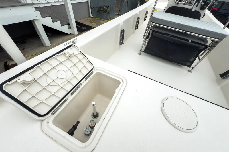 Slide: The Image of 2026 Carolina Skiff E20 JVX CC boat interior with open storage compartment. - 21