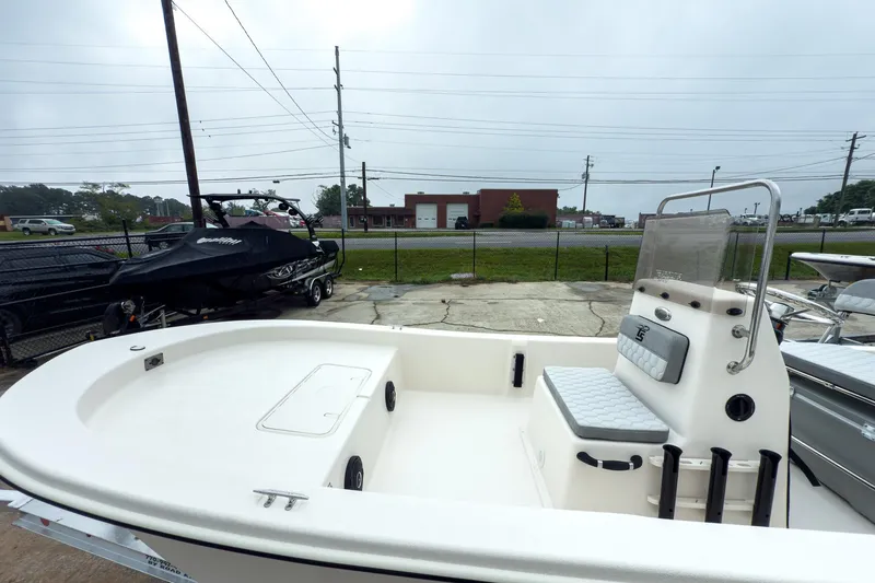 Slide: The Image of 2026 Carolina Skiff E20 JVX CC boat, white interior, parked outdoors. - 22