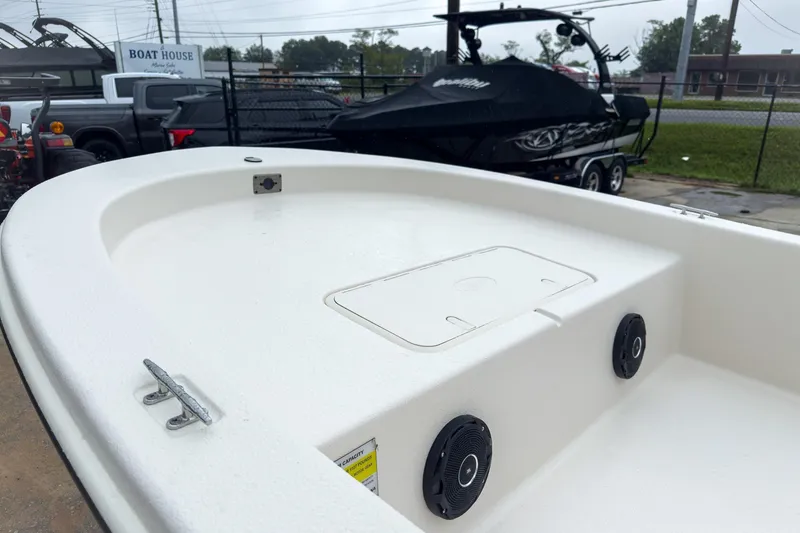 Slide: The Image of 2026 Carolina Skiff E20 JVX CC boat interior, featuring storage compartment and speakers. - 24