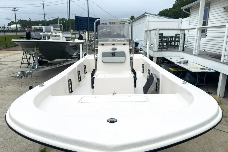 Slide: The Image of 2026 Carolina Skiff E20 JVX CC boat displayed outdoors, showcasing its spacious deck and console. - 25