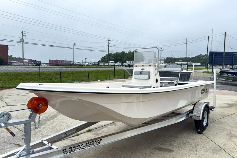 Slide: The Image of 2026 Carolina Skiff E20 JVX CC boat on trailer, parked outdoors. - 28