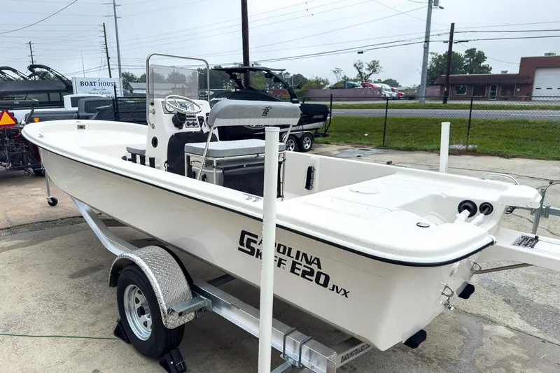 Slide: The Image of 2026 Carolina Skiff E20 JVX CC boat on trailer, parked outdoors. - 3