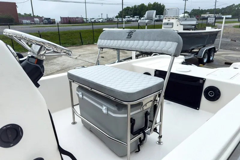 Slide: The Image of 2026 Carolina Skiff E20 JVX CC boat interior with steering wheel and cushioned seat. - 7