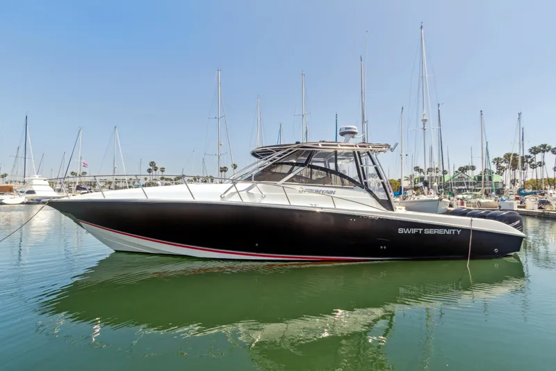 The Image of 2008 Fountain 38 Sport Cruiser boat docked in marina, clear sky background. - 0