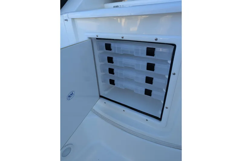 Slide: The Image of Storage compartment with tackle boxes on a 2008 Fountain 38 Sportfish Cruiser boat. - 10