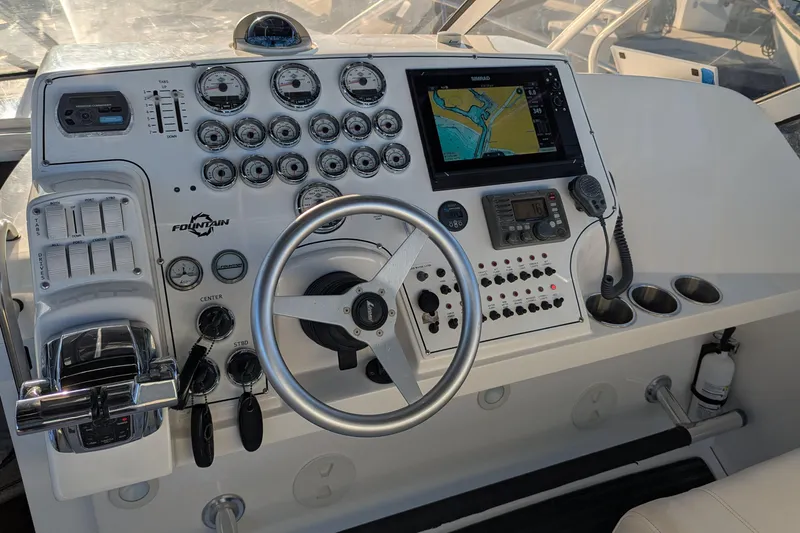 Slide: The Image of Control panel of 2008 Fountain 38 Sportfish Cruiser with steering wheel and navigation system. - 11