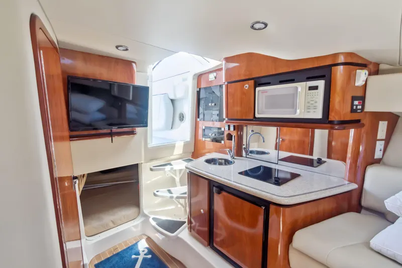 Slide: The Image of 2008 Fountain 38 Sport Cruiser interior with kitchenette, TV, and modern amenities. - 2