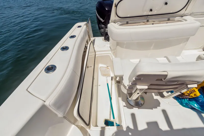 Slide: The Image of 2008 Fountain 38 Sport Cruiser deck with seating and storage, overlooking water. - 6