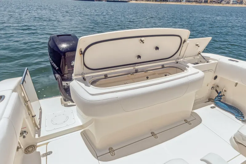 Slide: The Image of 2008 Fountain 38 Sport Cruiser boat with open storage compartment and Mercury outboard motor. - 7