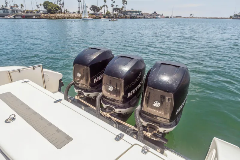Slide: The Image of Three Mercury outboard engines on a 2008 Fountain 38 Sport Cruiser in a marina setting. - 9