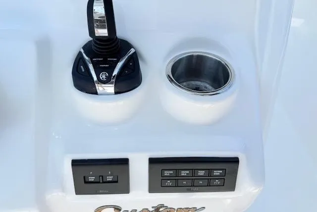 Slide: The Image of Control panel of 2025 Tidewater 272 CC Adventure boat with joystick and cup holder. - 12