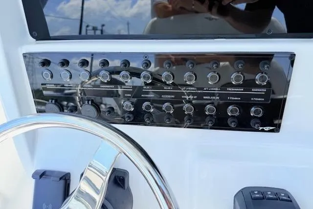 Slide: The Image of Control panel of 2025 Tidewater 272 CC Adventure boat with steering wheel. - 13