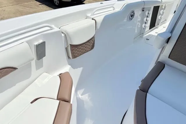 Slide: The Image of 2025 Tidewater 272 CC Adventure boat interior with cushioned seating and modern design. - 17