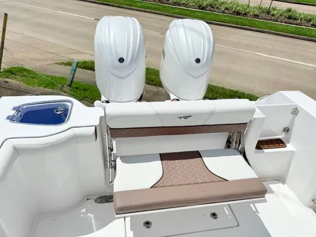 The Image of 2025 Tidewater 272 CC Adventure boat on trailer, side view, sunny day. - 2