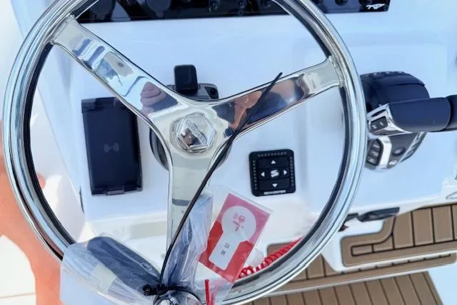 Slide: The Image of Steering wheel of 2025 Tidewater 272 CC Adventure boat, featuring modern controls and dashboard. - 22