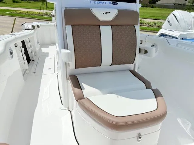 Slide: The Image of 2025 Tidewater 272 CC Adventure boat seating with cushioned armrests and modern design. - 8