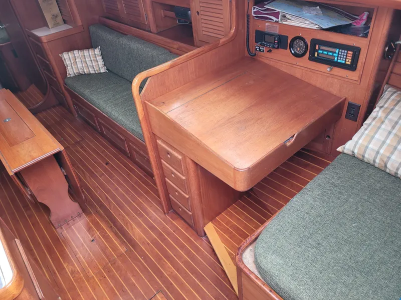 Slide: The Image of Interior of 1985 Bristol 38.8 sailboat with wooden cabinetry and green cushioned seating. - 22