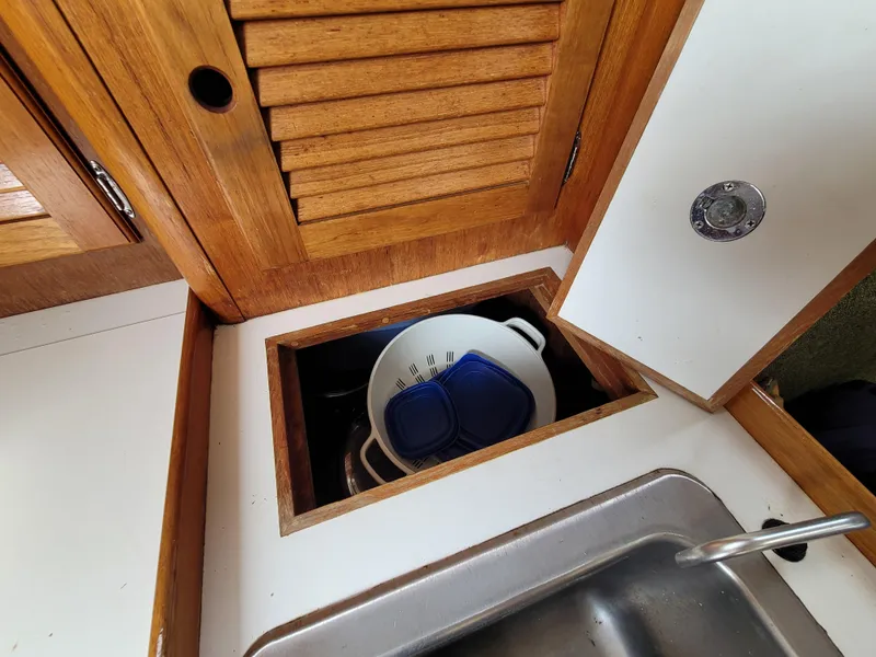 Slide: The Image of 1985 Bristol 38.8 yacht interior with wooden cabinetry and storage compartments. - 28