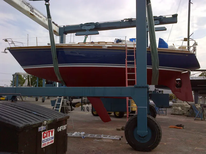 Slide: The Image of 1985 Bristol 38.8 sailboat "Archipelago" in dry dock, Norwalk CT, with red and blue hull. - 3