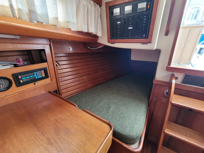 Slide: The Image of 1985 Bristol 38.8 yacht interior with wooden navigation desk and seating area. - 31