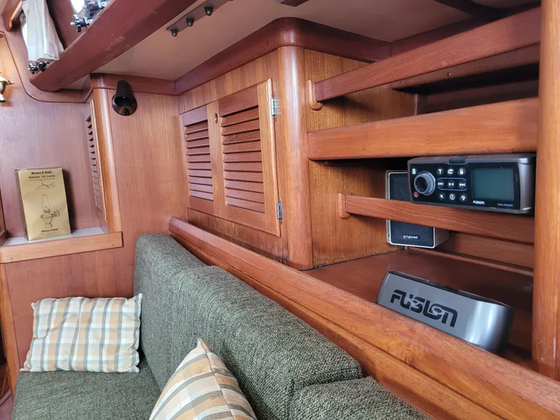 Slide: The Image of Interior cabin of 1985 Bristol 38.8 sailboat with wooden paneling and cushioned berth. - 32