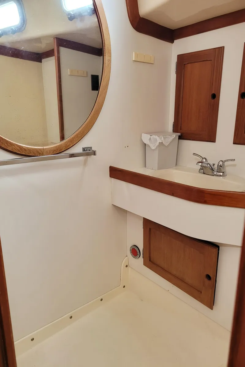 Slide: The Image of Bathroom sink area in a 1985 Bristol 38.8 yacht with wooden cabinets. - 37