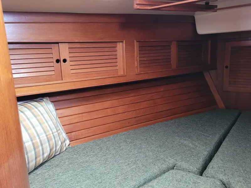 Slide: The Image of 1985 Bristol 38.8 yacht bathroom with toilet and sink, featuring wooden accents. - 38