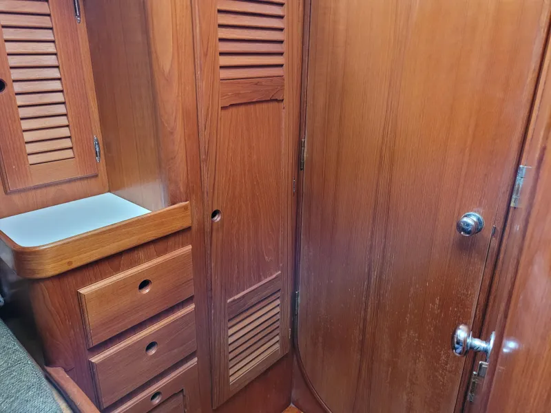 Slide: The Image of 1985 Bristol 38.8 yacht interior with wooden paneling and cushioned bed. - 40