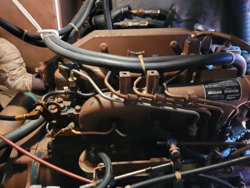 Slide: The Image of Radio equipment and storage on a 1985 Bristol 38.8 boat, featuring a microphone and navigation tools. - 46