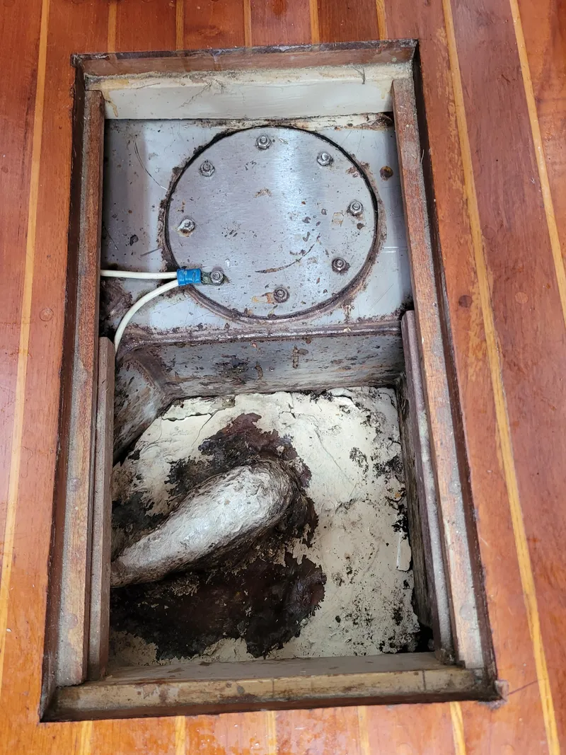 Slide: The Image of Engine compartment of a 1985 Bristol 38.8 sailboat, featuring hoses and mechanical components. - 50