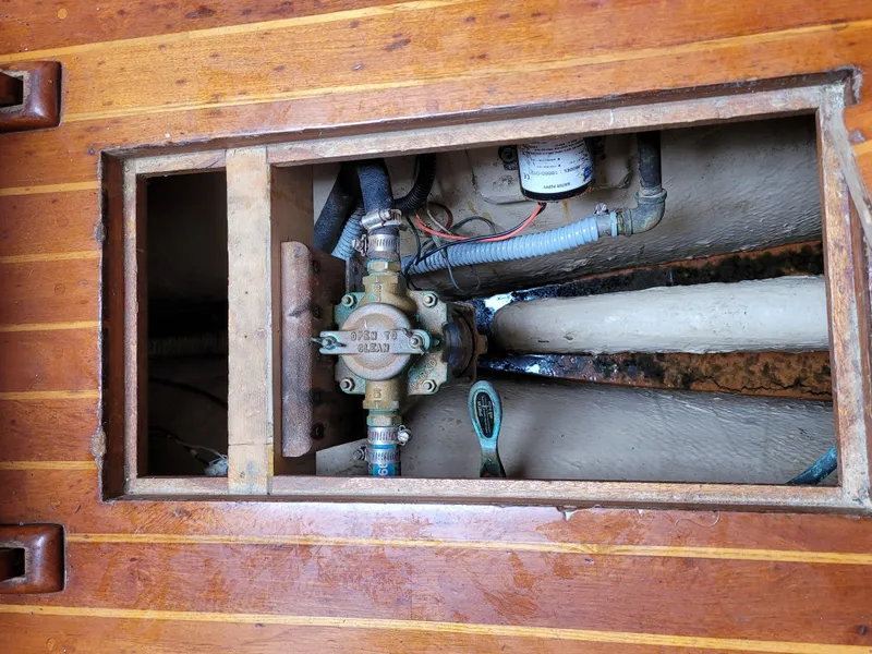 Slide: The Image of 1985 Bristol 38.8 engine compartment with blue and white machinery, hoses, and warning label. - 51