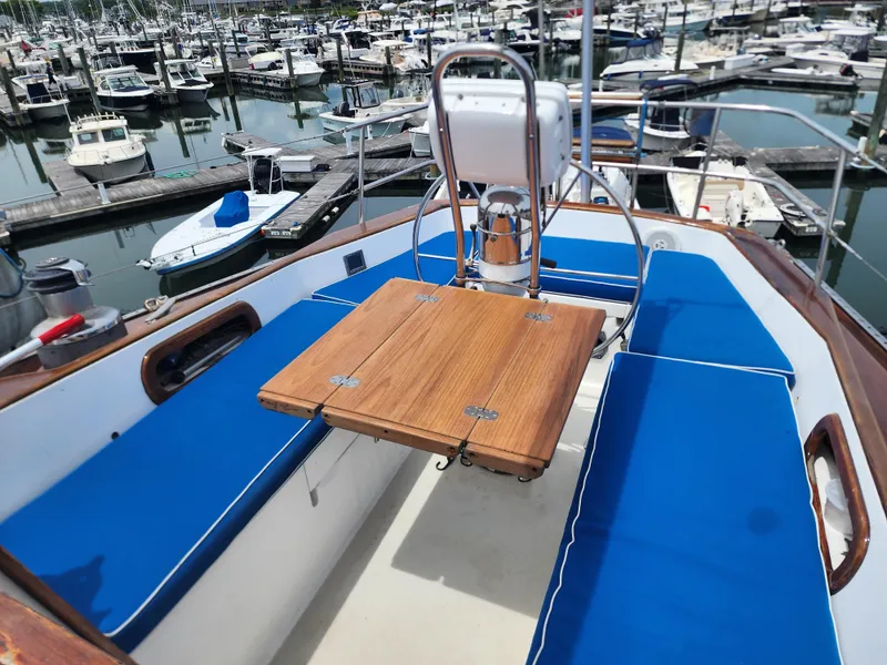 Slide: The Image of 1985 Bristol 38.8 sailboat cockpit with wooden accents, docked at marina. - 6